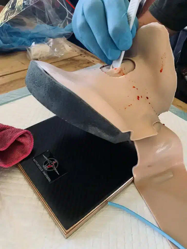 Students securing a CRIC during classroom simulations of advanced surgical airway techniques